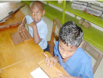 Boys with visual impairment learning Braille in Fiji