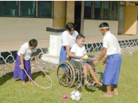 Boy with physical disability having fun with friends